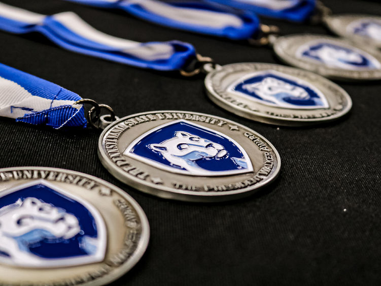 Penn State award medallions on a table 