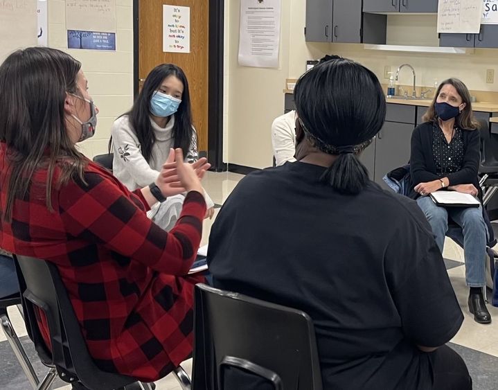 Students sitting in circle talking