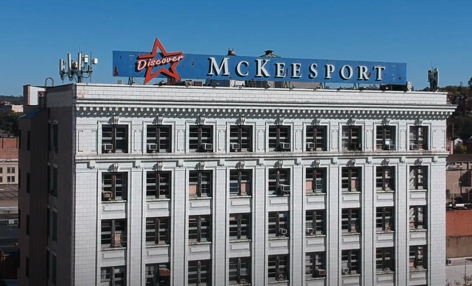 Building with a sign on the roof that reads Mckessport.