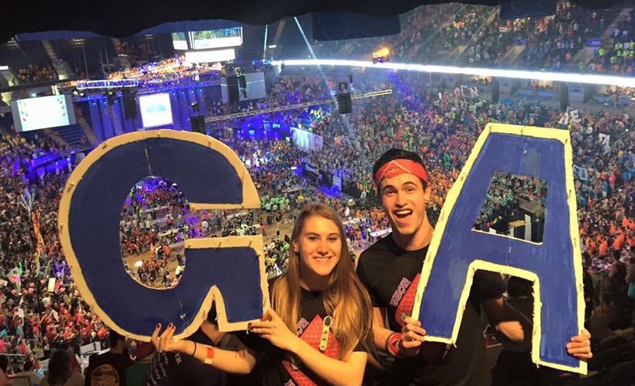 dancers holding letters G and A dancers holding letters G and A