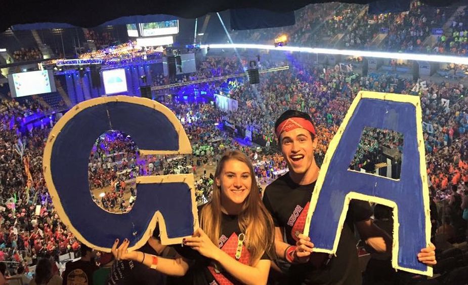 dancers holding letters G and A